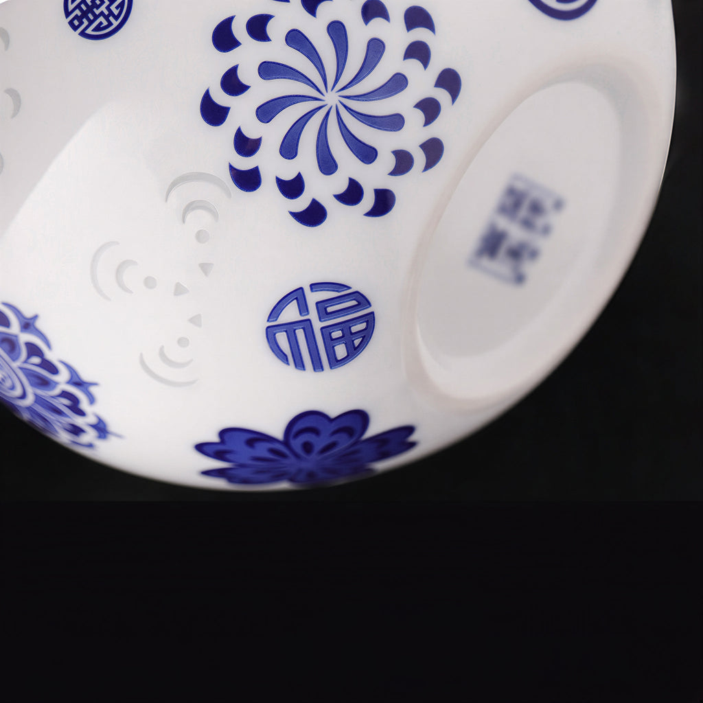 Close view of blue blessing characters among floral motifs and linglong windows