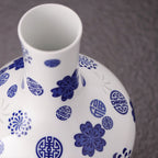Close view of the straight white porcelain neck with cobalt floral and blessing motifs