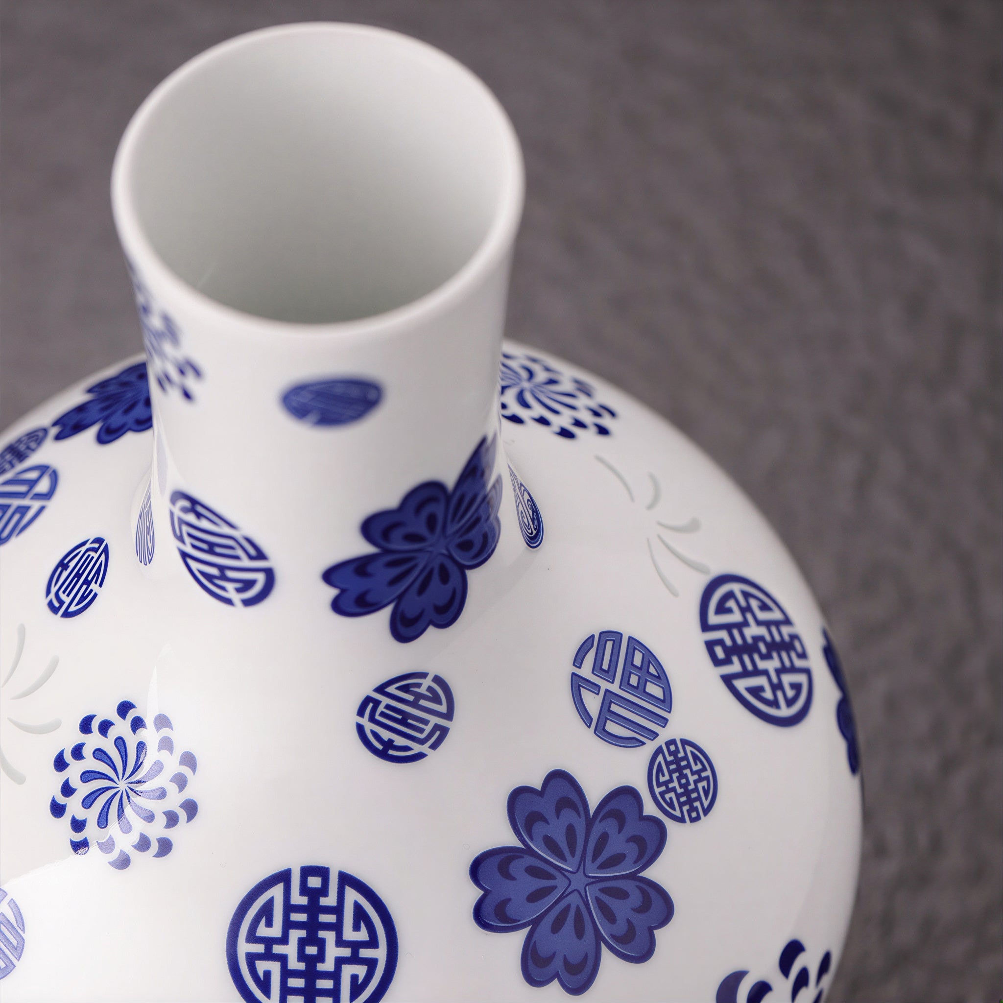 Close view of the straight white porcelain neck with cobalt floral and blessing motifs