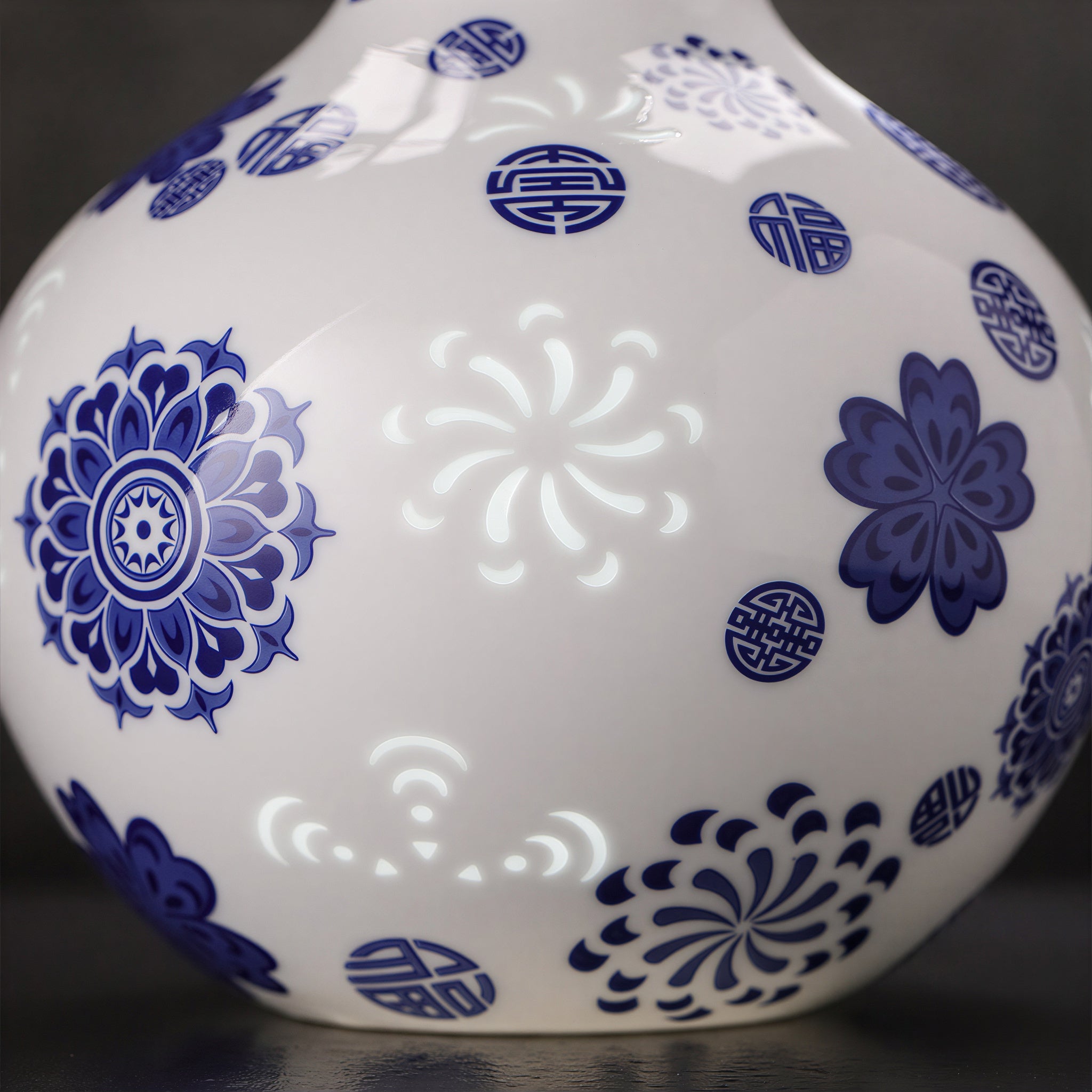 Close view of a translucent floral linglong window between cobalt medallions