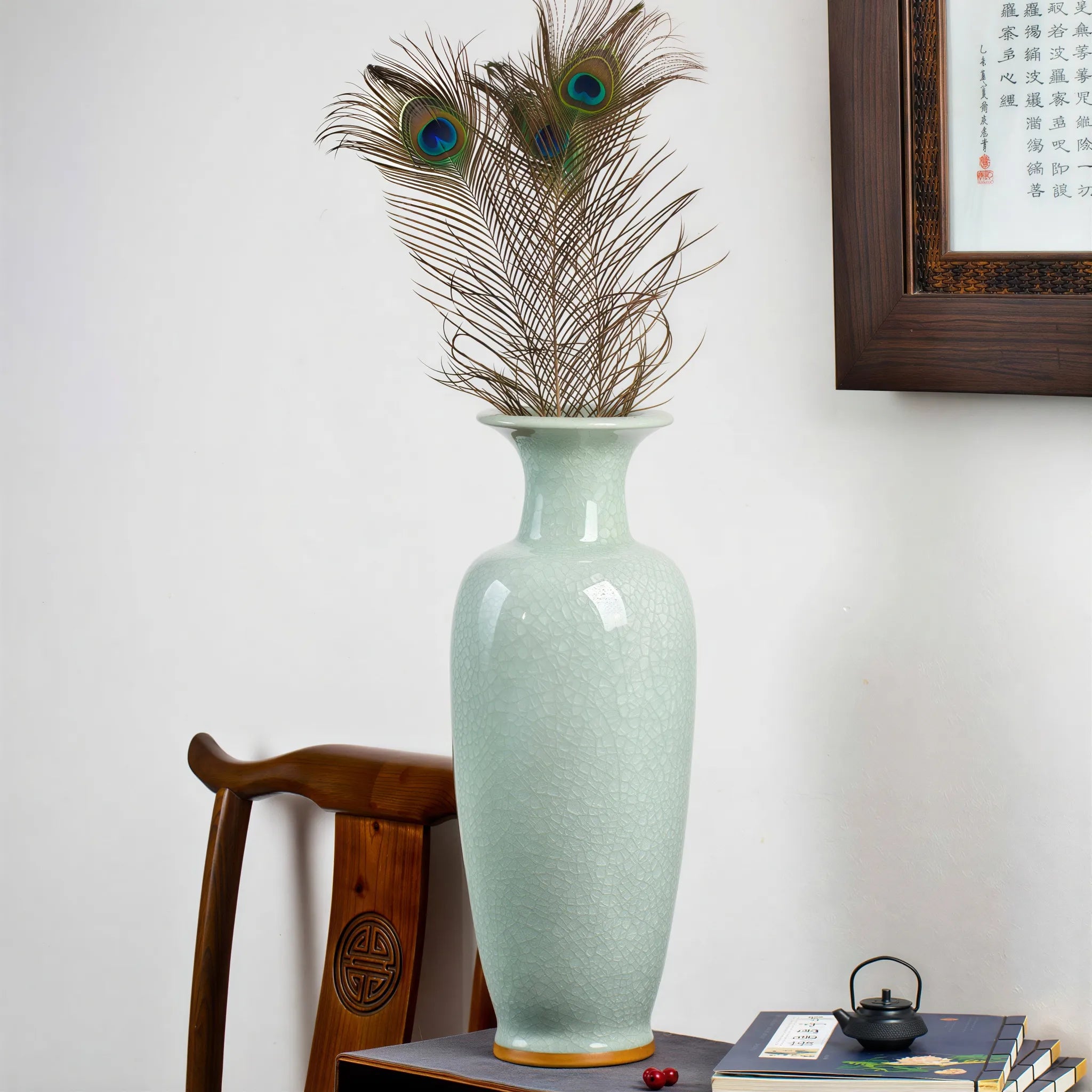 Pale celadon floor vase arranged with peacock feathers