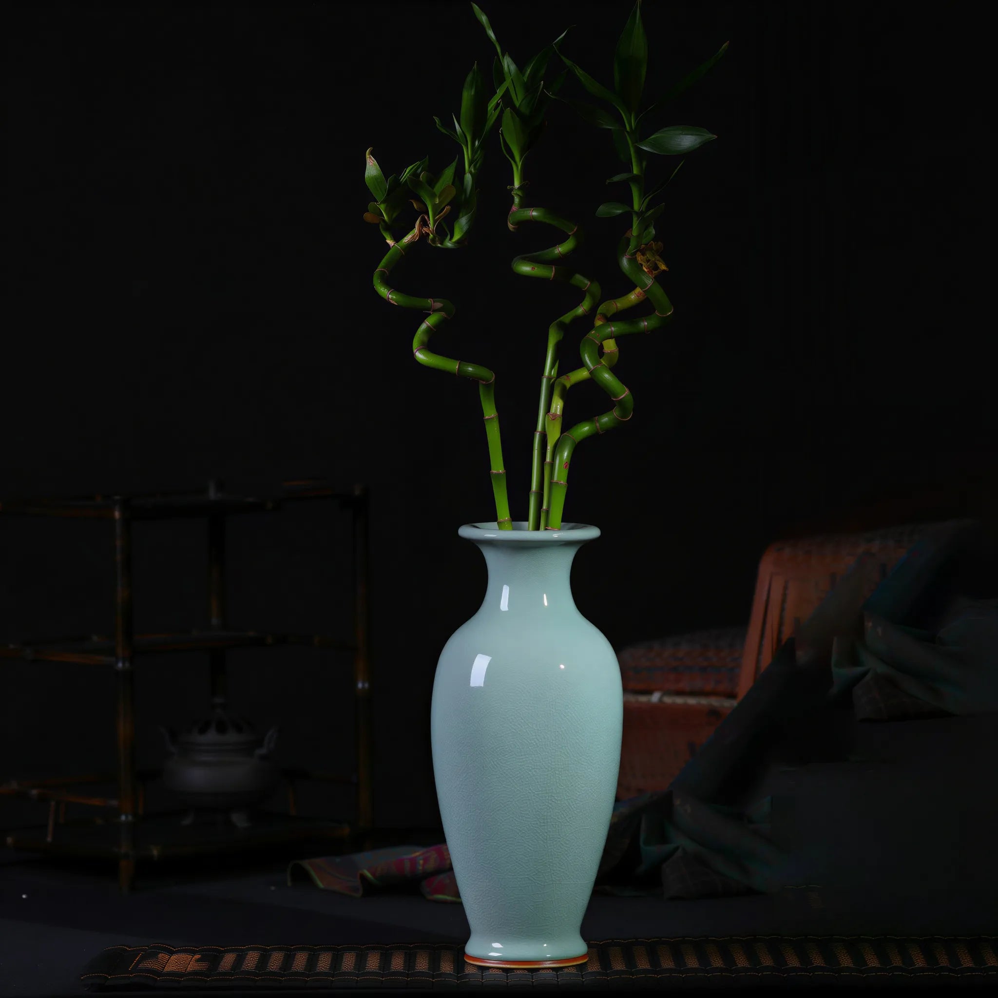 Pale celadon Guanyin vase arranged with lucky bamboo