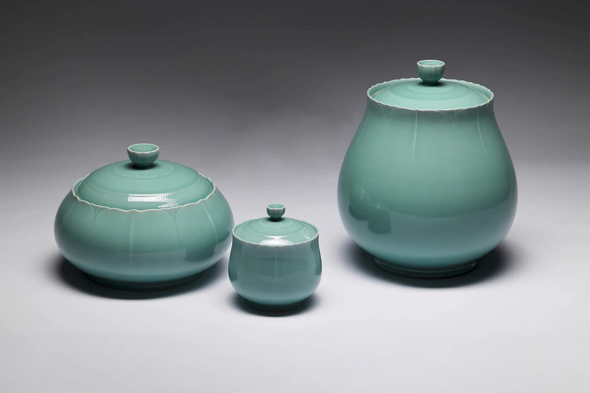 Three green Longquan celadon vessels with fluted bodies and scalloped lids