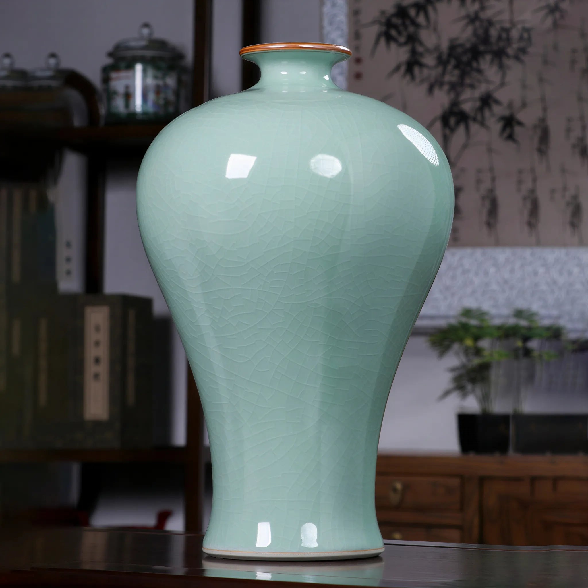 Celadon Meiping vase displayed on a contemporary cabinet