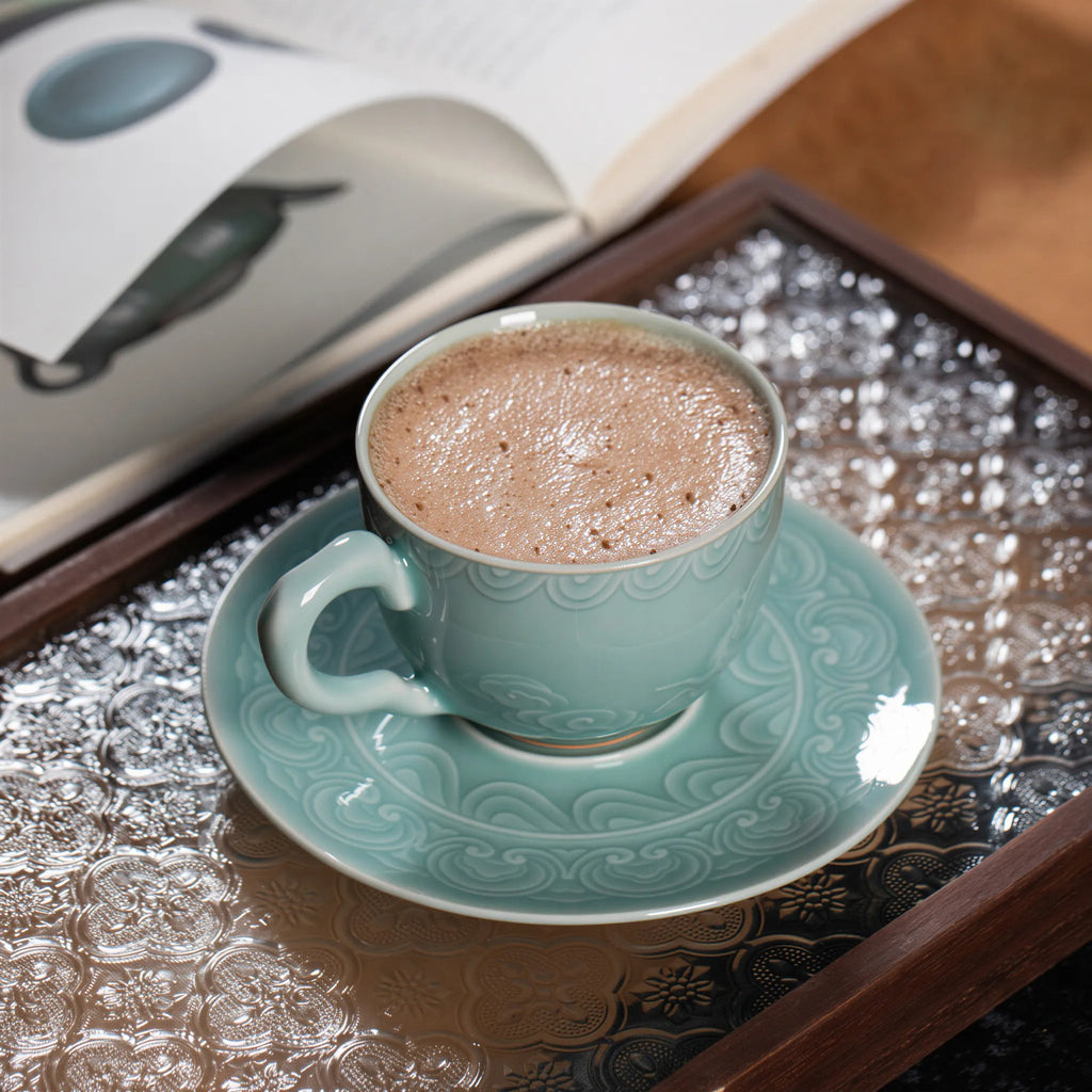 Plum Green celadon cup filled with coffee