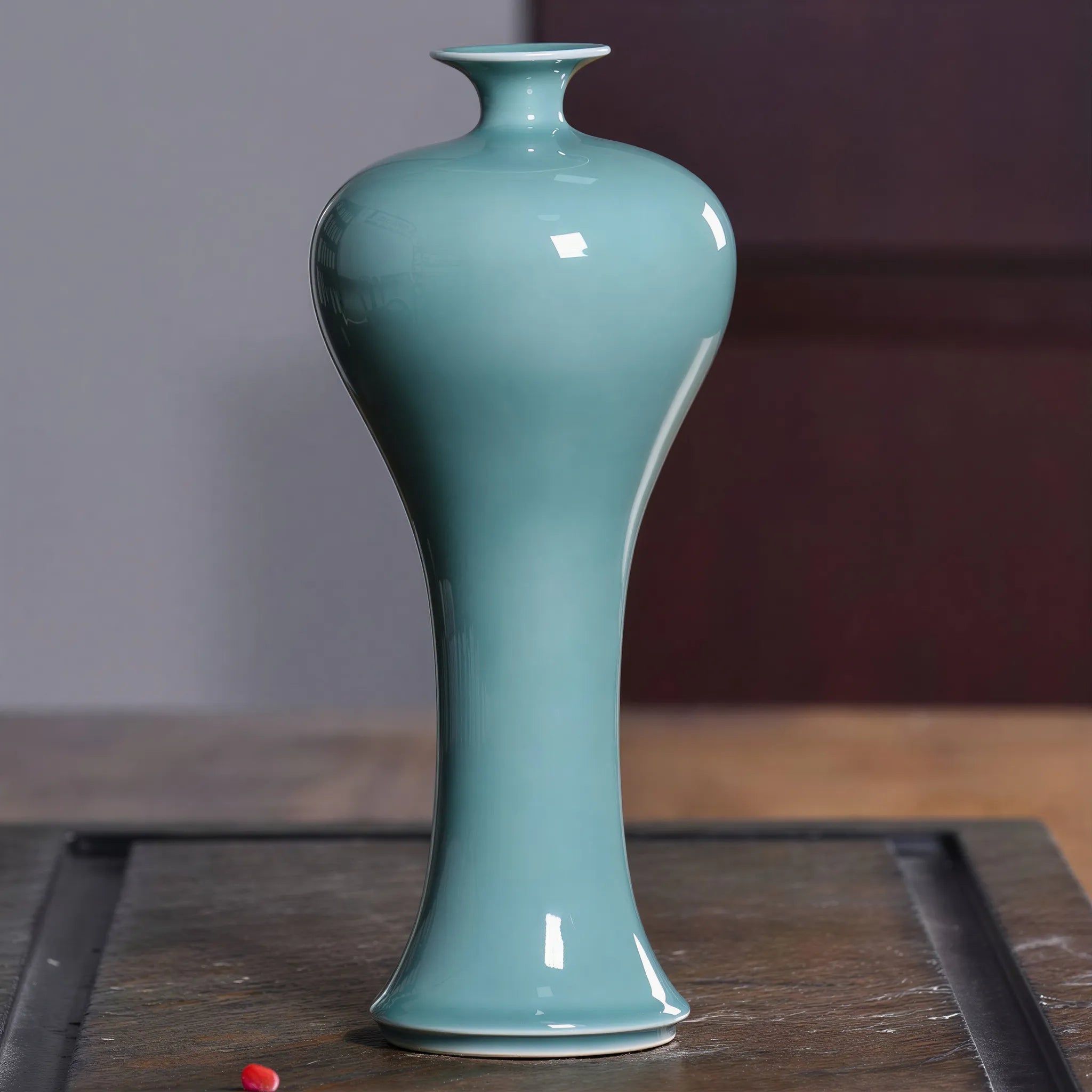 Side profile of the Sky Cyan Celadon meiping vase on a tea tray