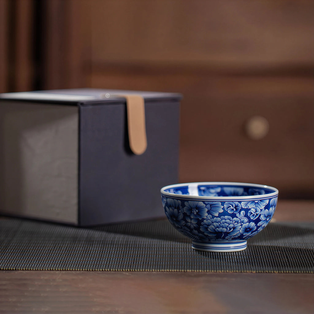 Side profile of the millefleurs teacup beside its box