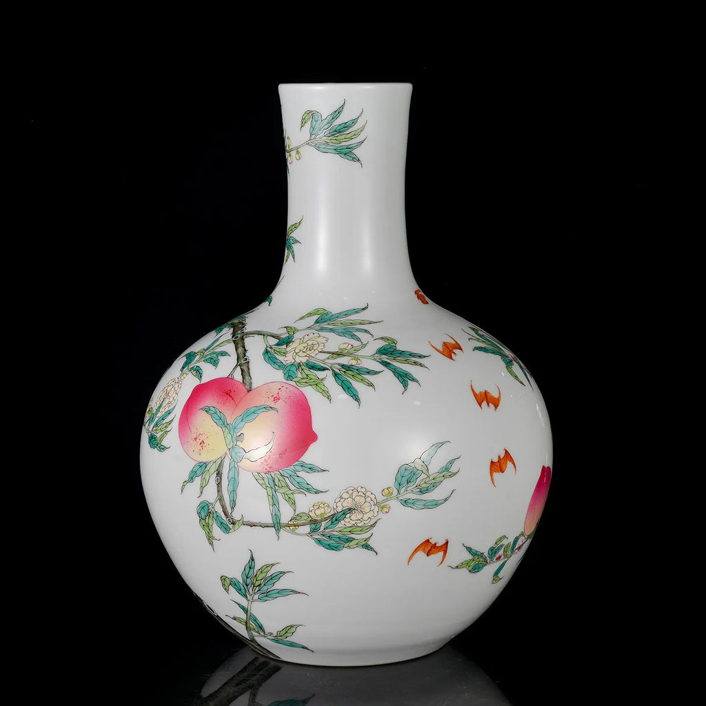 Famille rose nine-peach Tianqiu vase displayed on a console