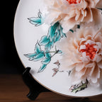 Painted peony leaves beneath raised porcelain flowers
