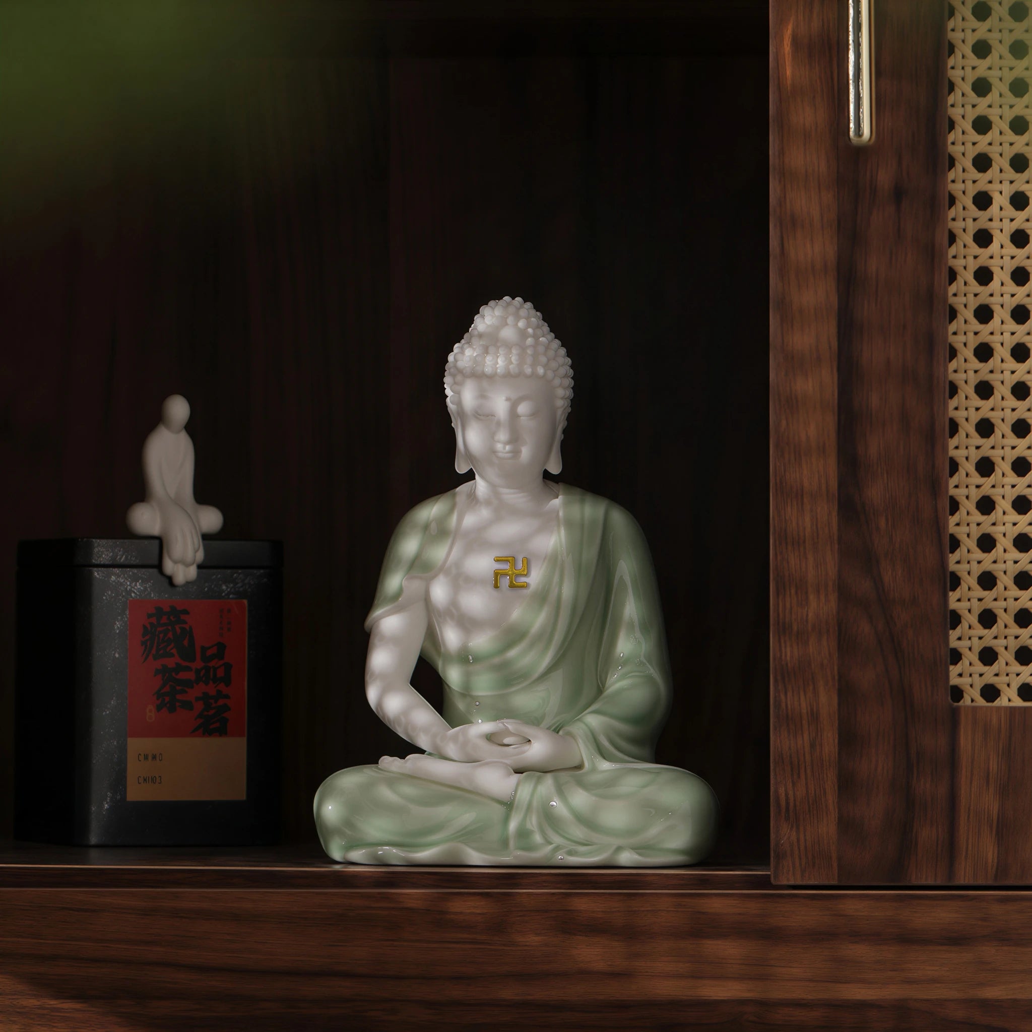 Pale celadon Amitabha Buddha sculpture displayed inside a wooden cabinet