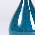 Close view of vertical glaze movement on peacock green porcelain