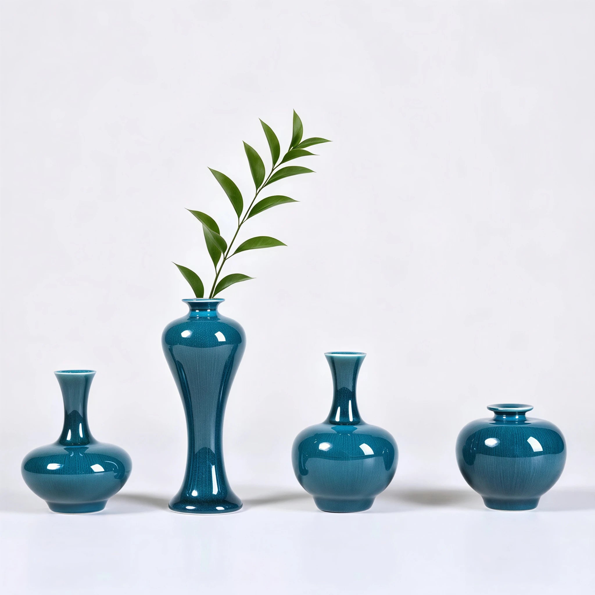 Peacock green porcelain vases styled with single green stems
