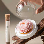 Angled view of the pink carnation, white base and incense tube