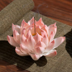 Blush pink porcelain lotus holding a single incense stick