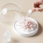 Fragrance oil being applied to the white porcelain lotus
