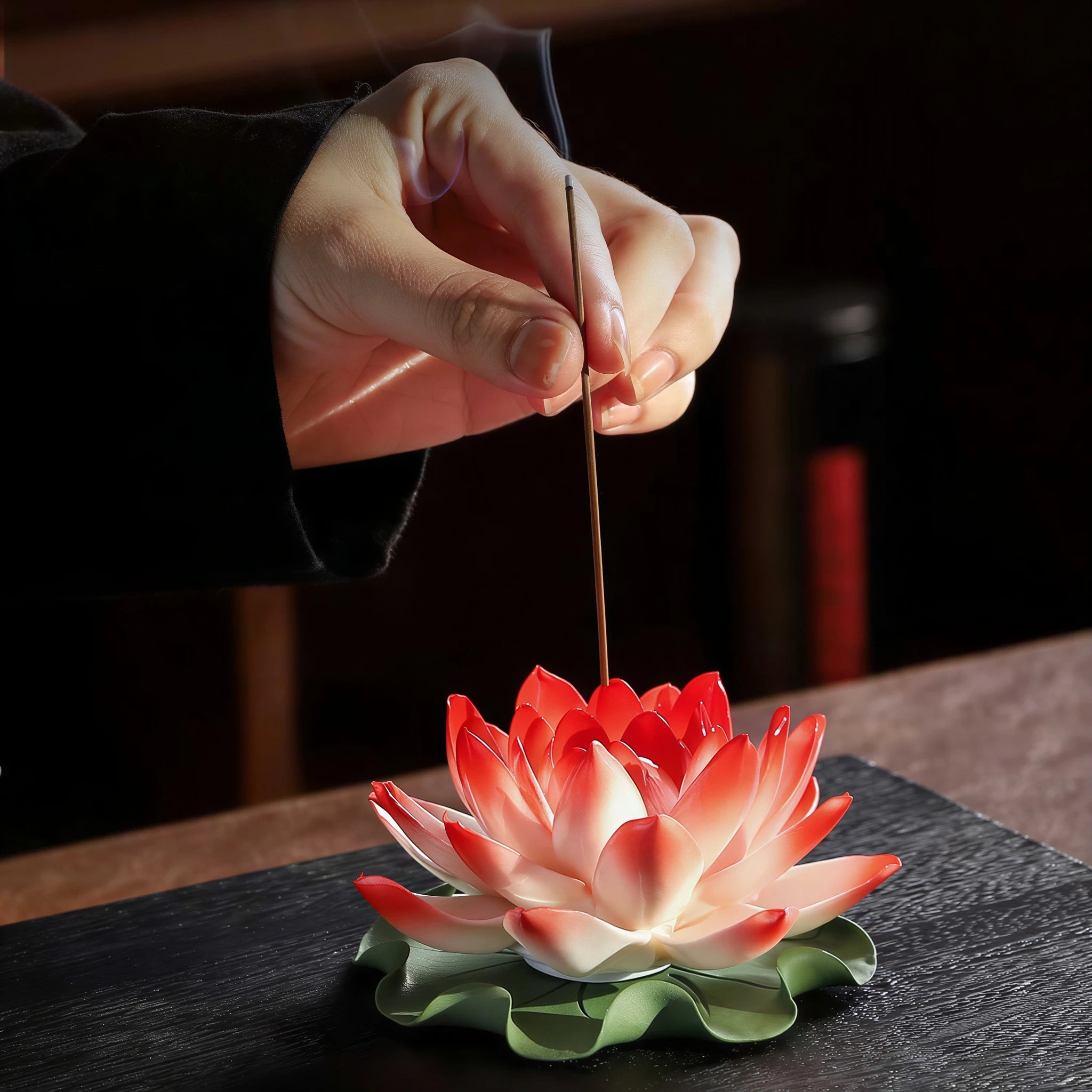 Incense stick being placed into the porcelain lotus center