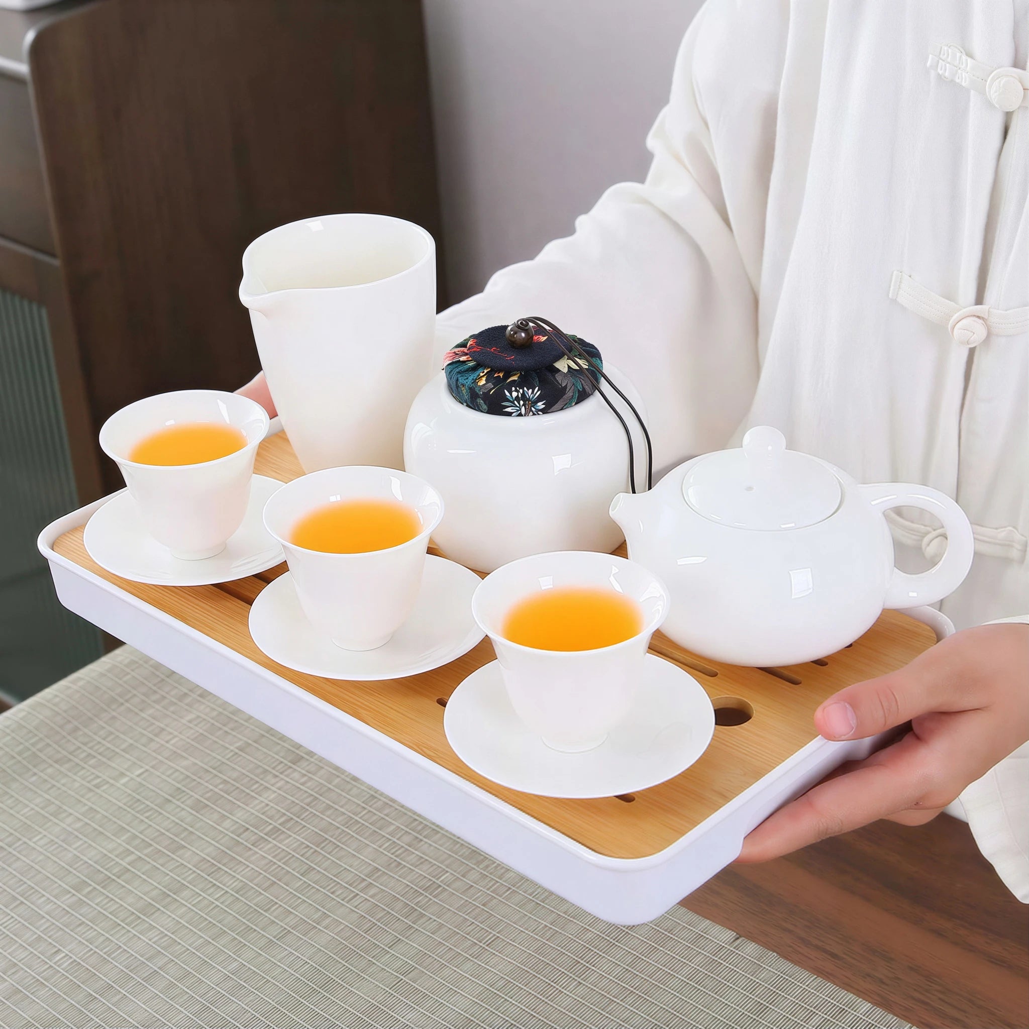 Complete porcelain tea service carried on the bamboo tray