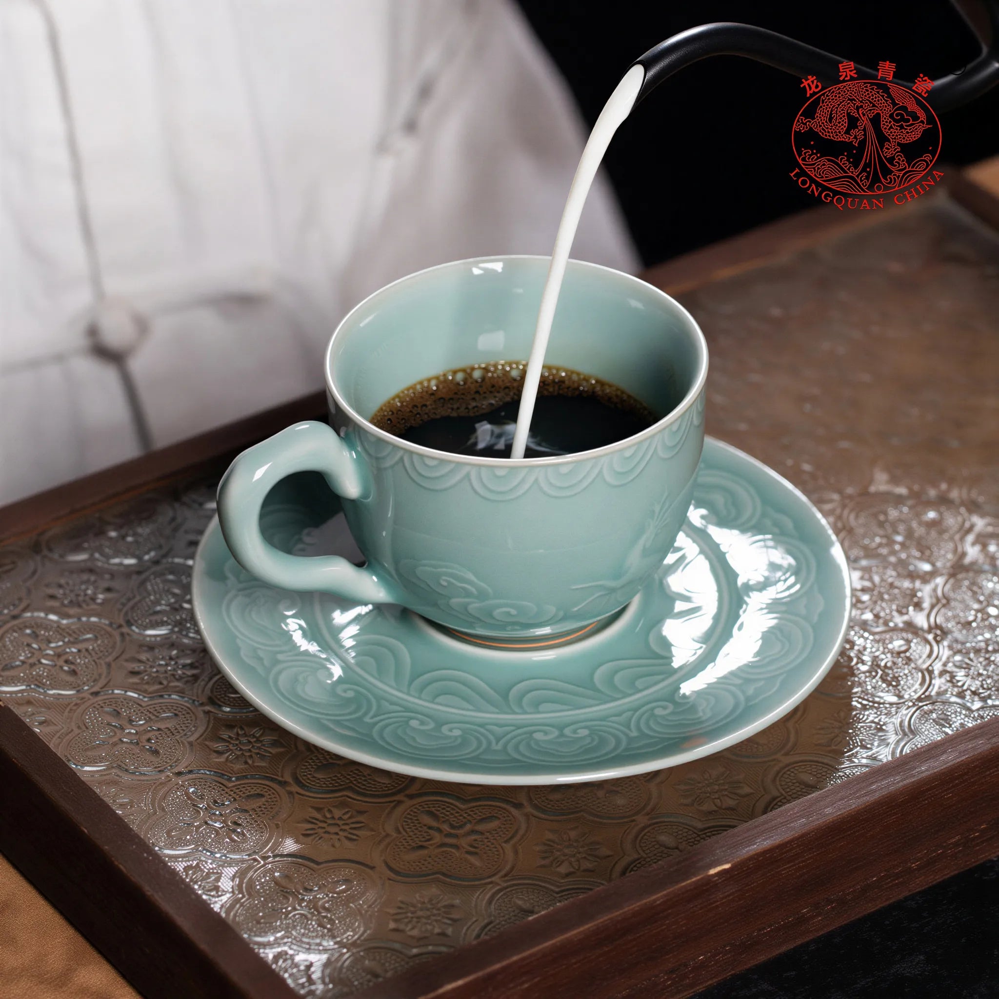 Coffee being poured into the Longquan celadon cup