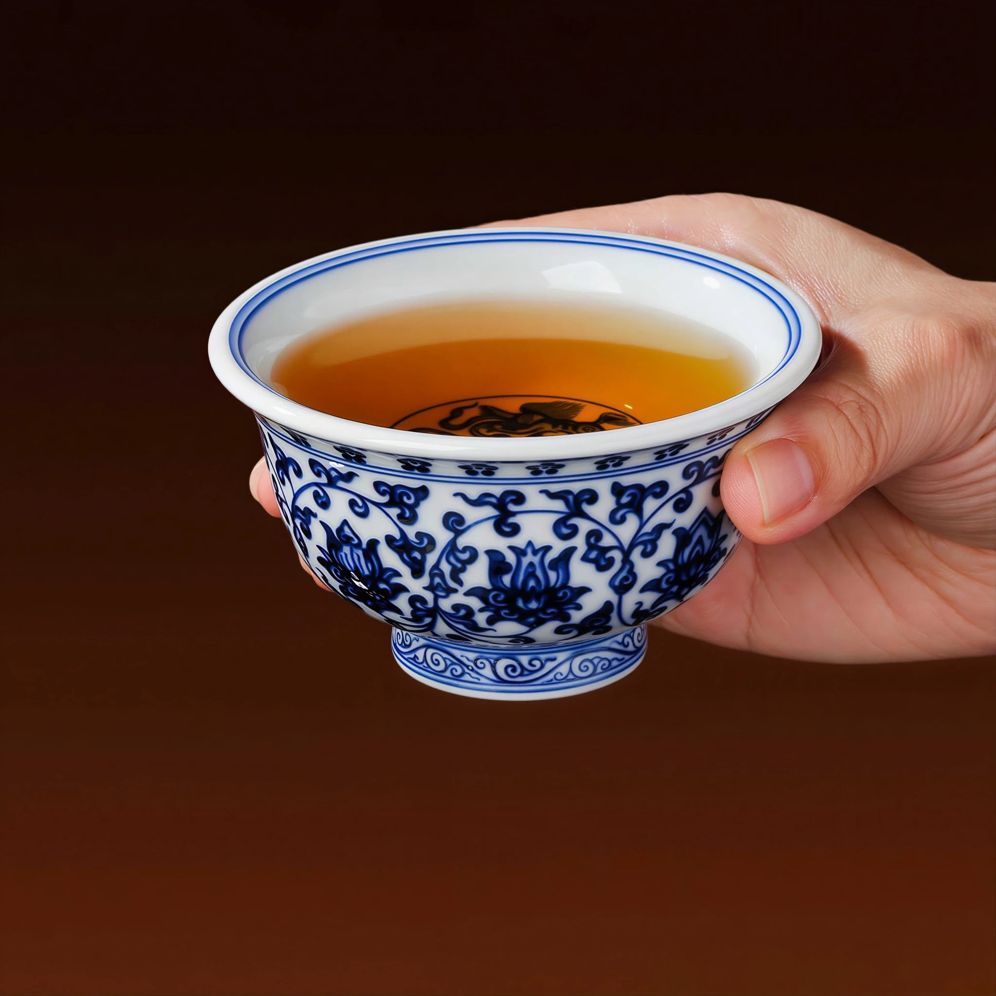 Tea being poured into the blue-and-white press-hand cup