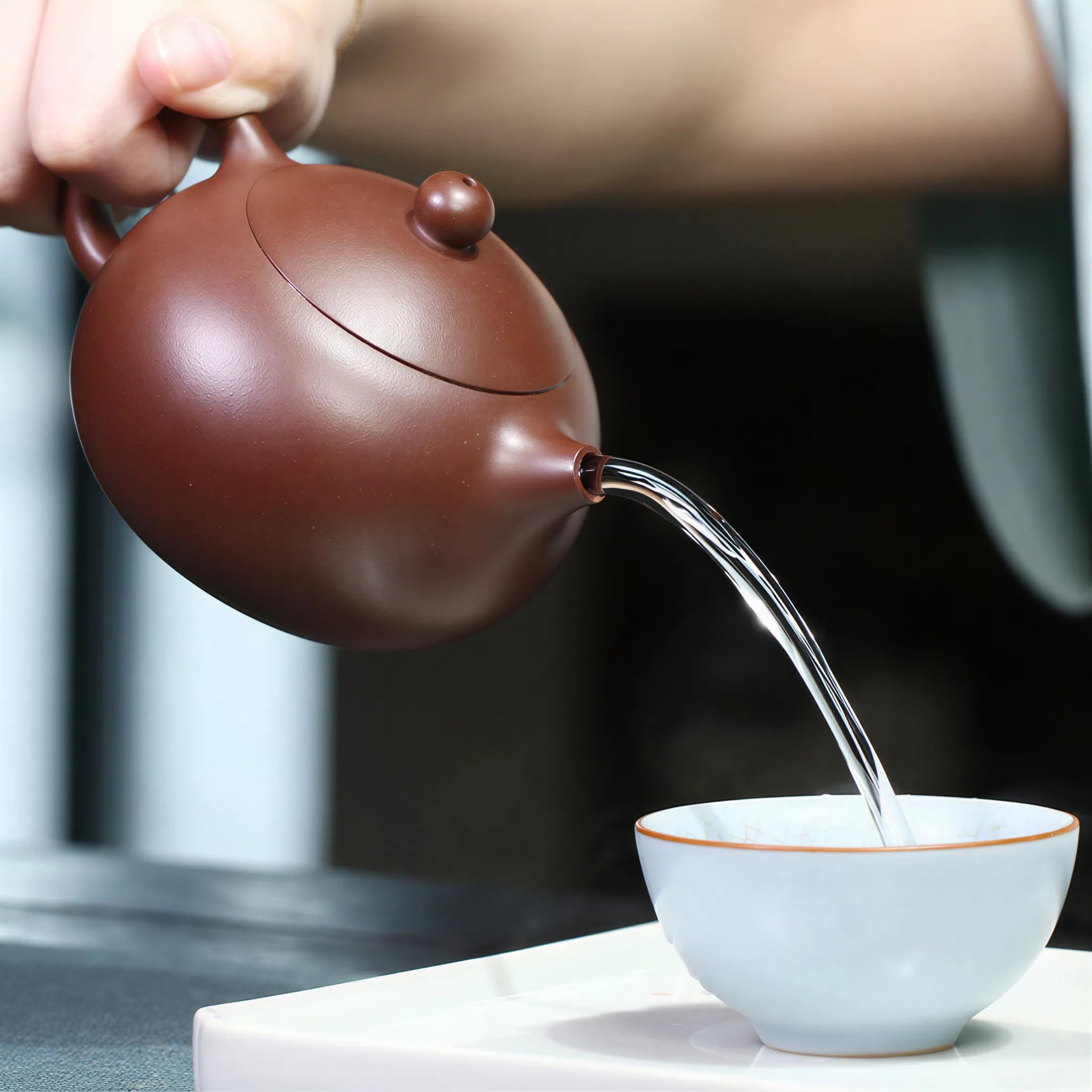 Water pouring from the short spout of the Xishi teapot