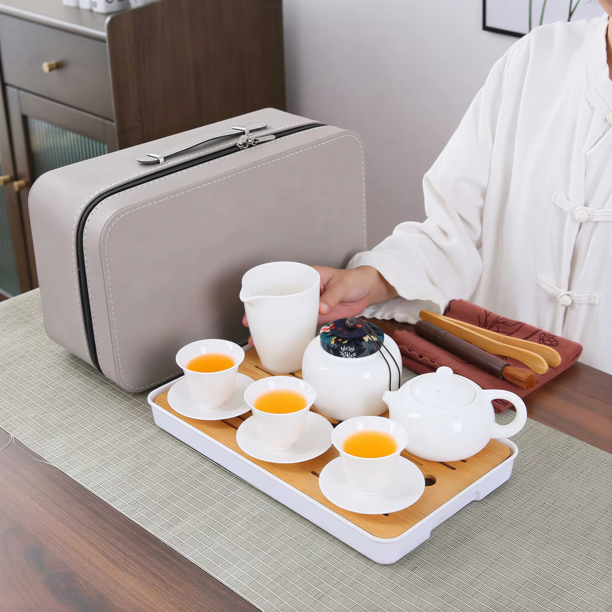 Portable white porcelain gongfu tea set being prepared