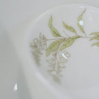 Video of the Jingdezhen Spring Dawn eleven-piece porcelain dinnerware set, showing its botanical decoration, bowl profiles, condiment dishes, spoons, and silver-colored rims.