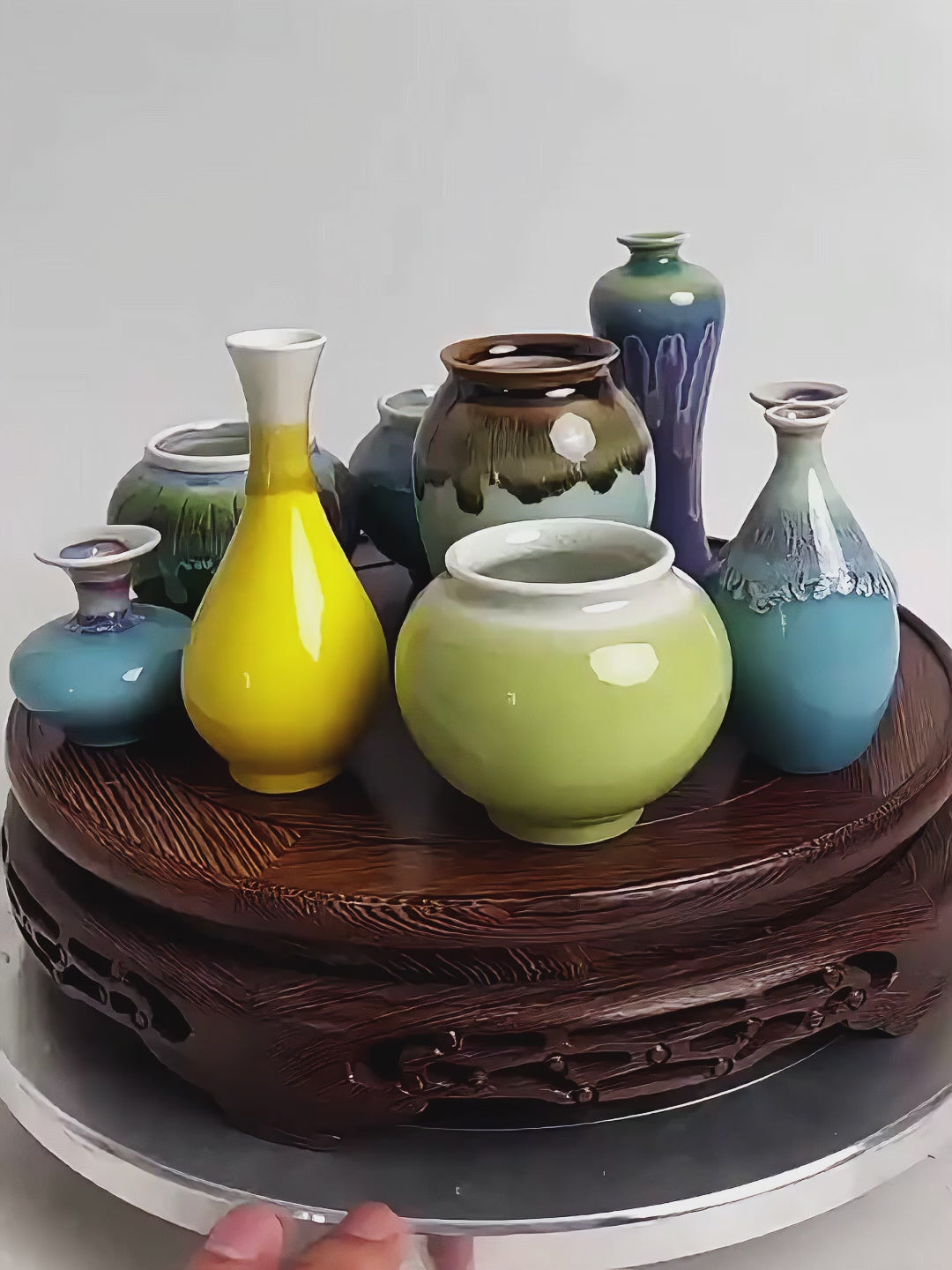 Product video showing the small scale, glossy blue reactive glaze, and tabletop styling potential of Jingdezhen miniature porcelain vases for water, single stems, and small cuttings.