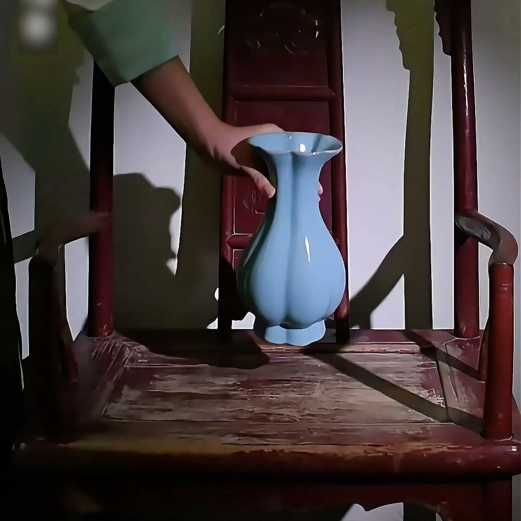 A kiln scene followed by a sky-blue Haitang vase being handled and displayed on a wooden chair.