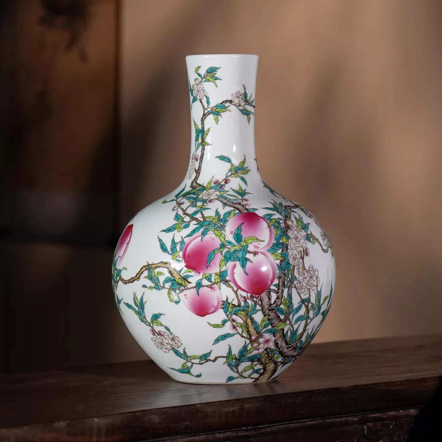 Front view of a Qianlong-style famille rose nine-peach Tianqiu vase