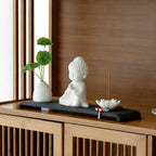 White porcelain Buddha altar set displayed on a cabinet