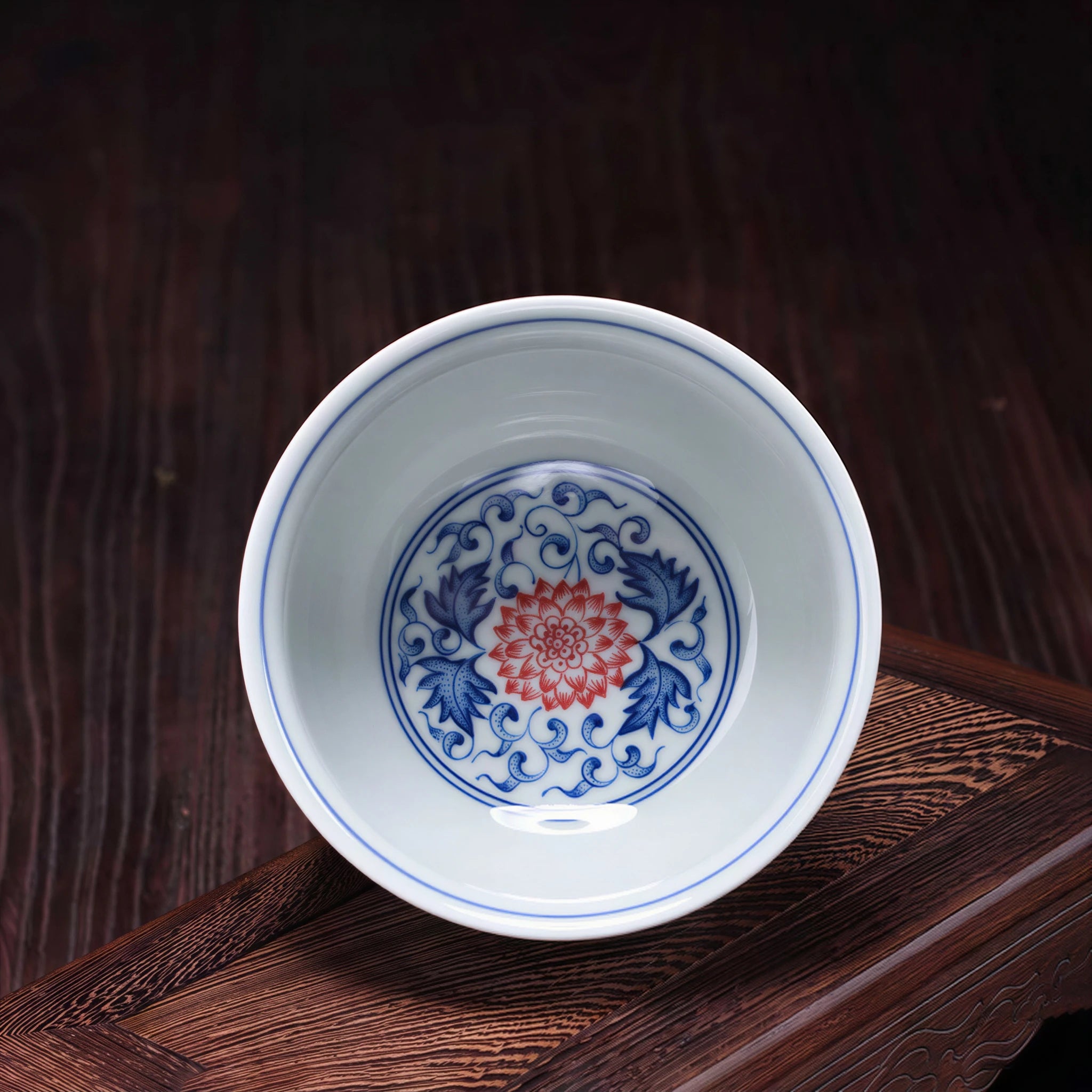 Interior lotus motif in underglaze red and cobalt blue