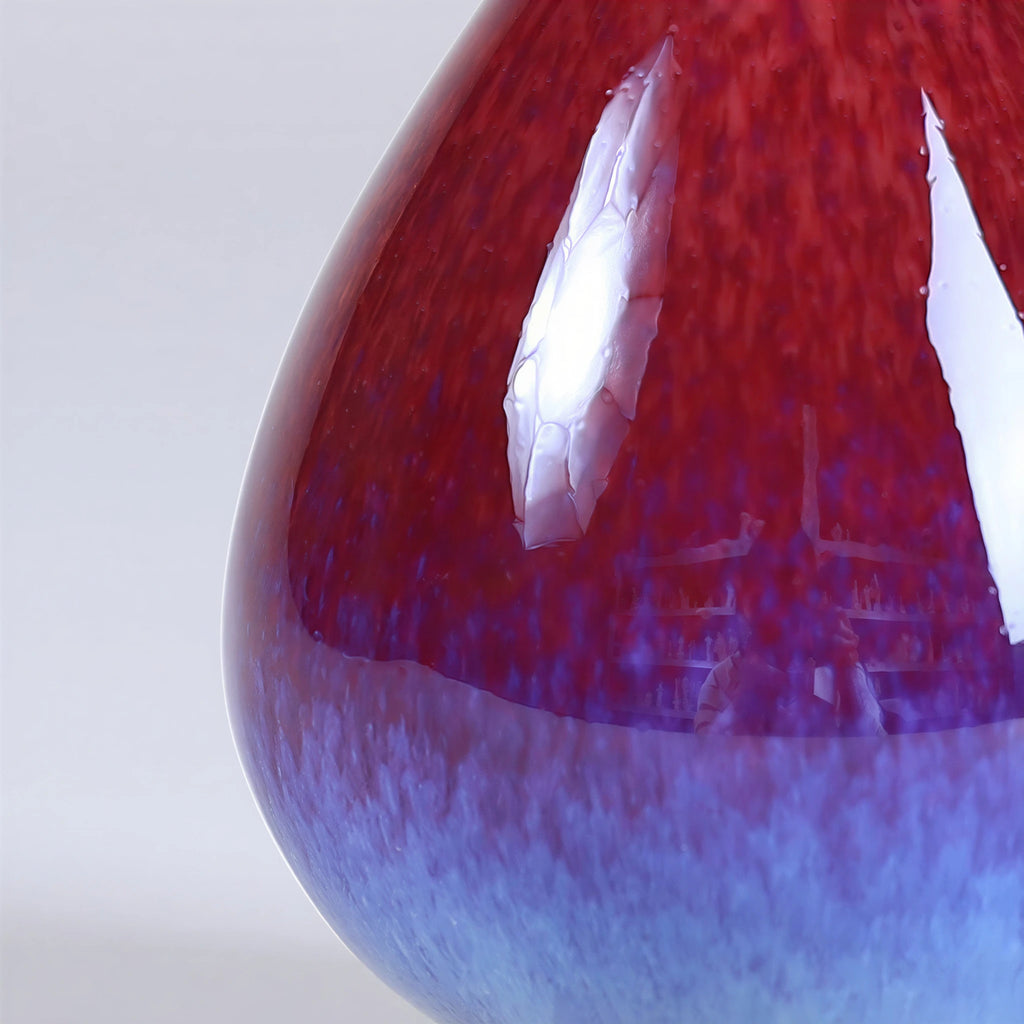 Close view of the rose-purple glaze shifting into blue near the lower body.