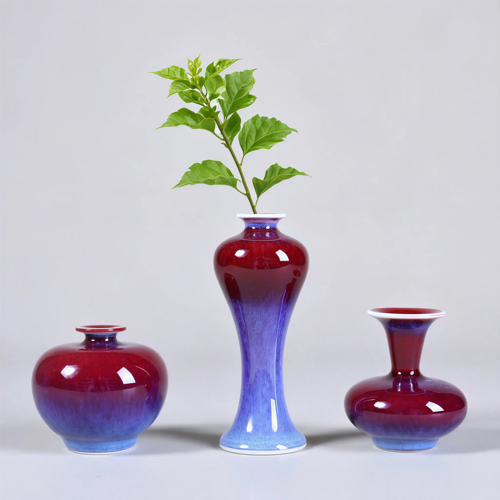 Three rose-purple mini porcelain vases arranged with green cuttings.