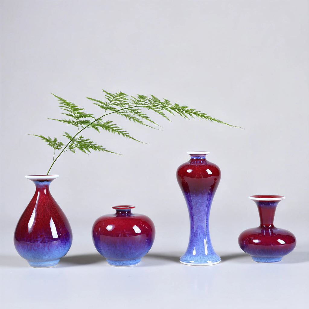 Rose-purple mini porcelain vases holding delicate green stems on a white surface.