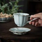 Ru-style celadon scalloped coffee cup in a quiet table setting