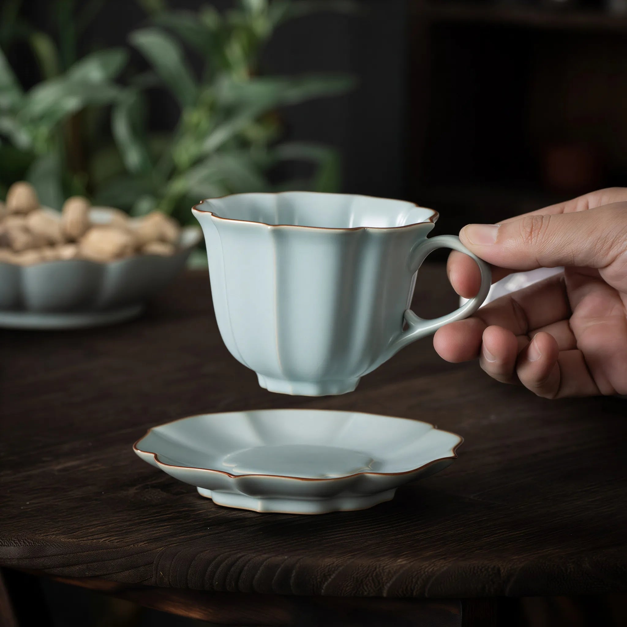 Ru-style celadon scalloped coffee cup in a quiet table setting