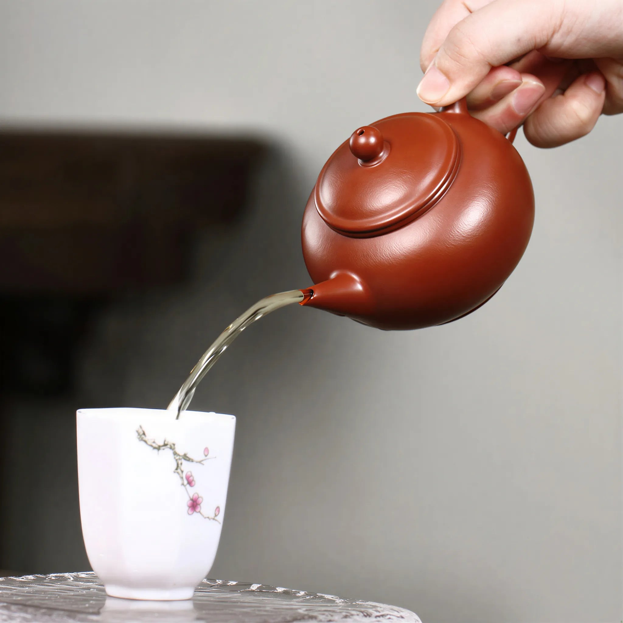 Tea pouring from the 200 ml Shui Ping Yixing teapot