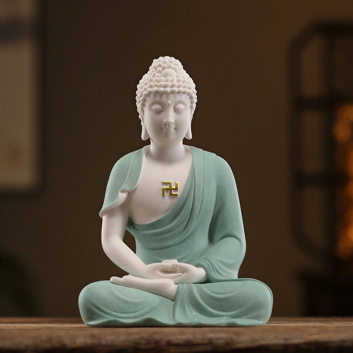 Soft green and white seated Amitabha Buddha with gold-toned wan emblem