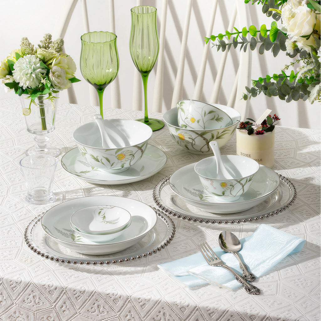 Spring Dawn floral porcelain bowls, plates, and condiment dishes arranged across a table set for two.
