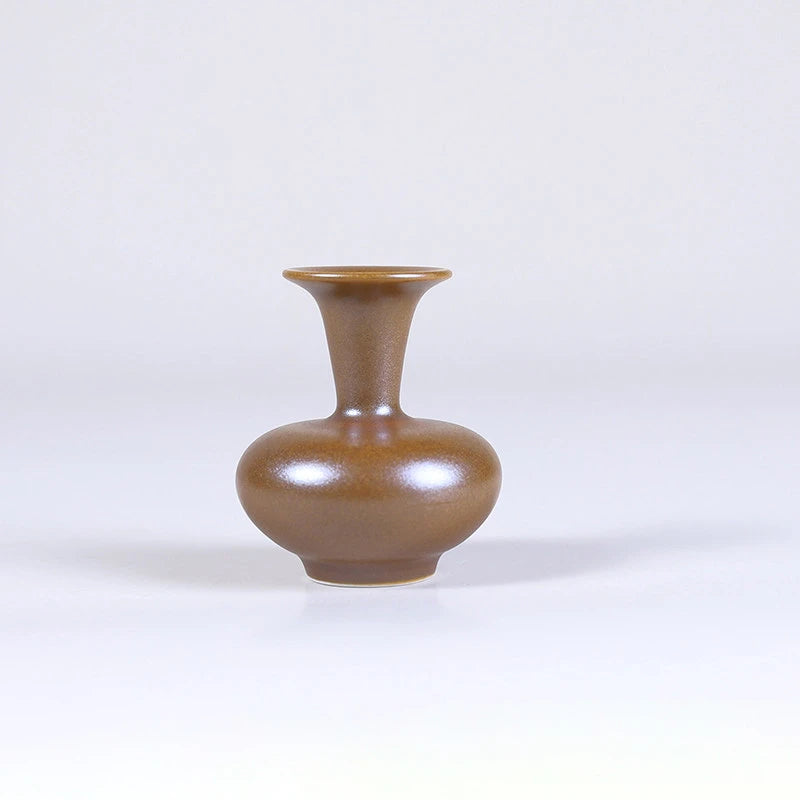 Squat maple-yellow mini porcelain vase with a short neck.
