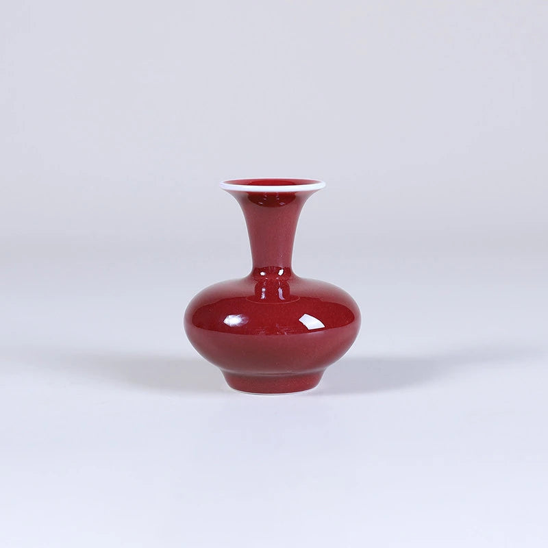 Squat oxblood red porcelain vase with narrow neck