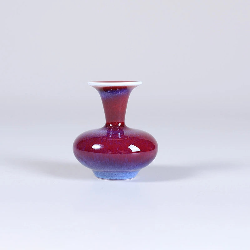 Low squat rose-purple porcelain vase with a narrow neck and small mouth.