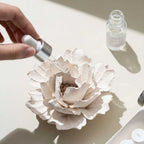 Fragrance oil being applied to the porous ceramic blossom