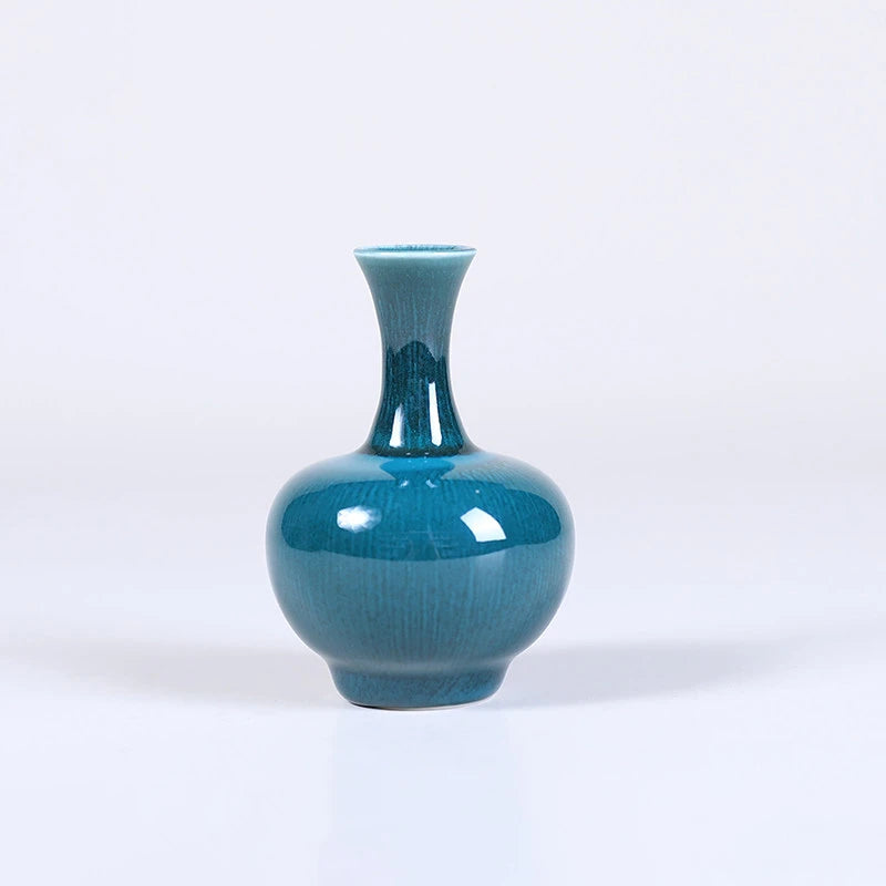 Front view of a globular peacock-green Tianqiu vase with a flared mouth