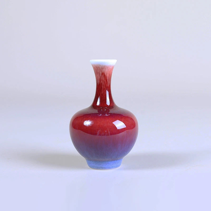Rose-purple Tianqiu mini porcelain vase with a rounded body and narrow neck.