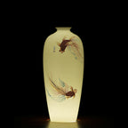 Backlit goldfish Meiping vase showing the warm translucency of the white porcelain body
