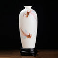 Front view of a translucent white porcelain Meiping vase with two long-finned goldfish