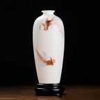 Front view of a translucent white porcelain Meiping vase with two long-finned goldfish