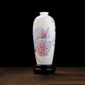 Front view of a translucent white porcelain Meiping vase with pink and blue hydrangeas