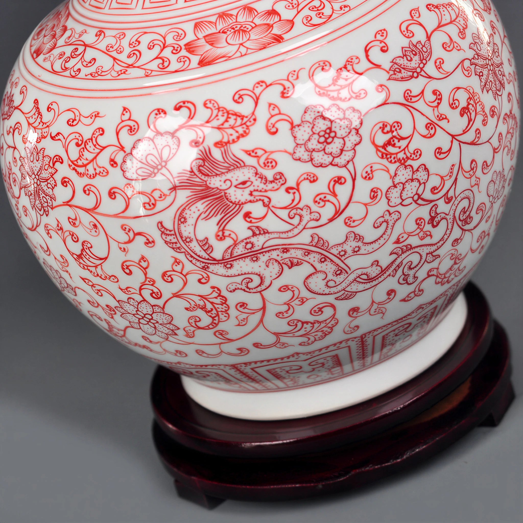 Underglaze-red botanical and border decoration across the porcelain body